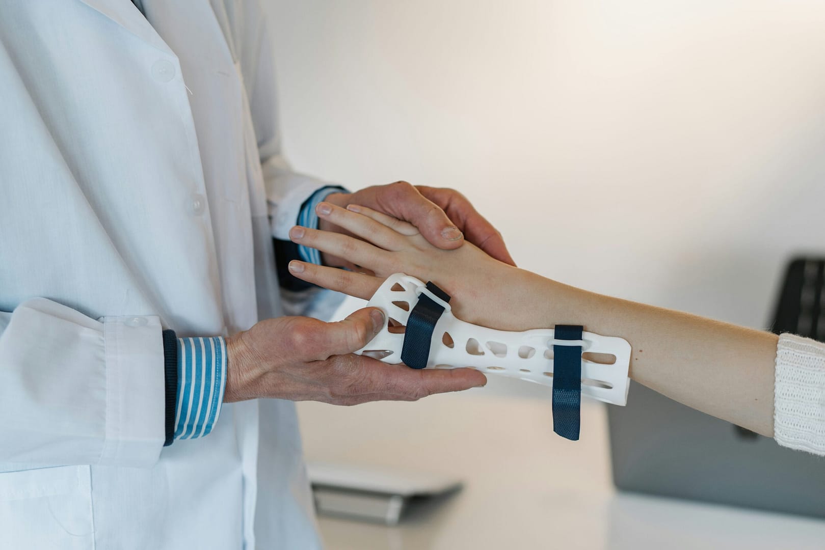 doctor examining a patient in a hand brace